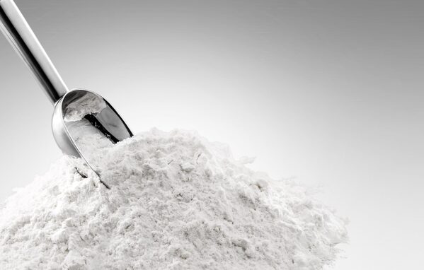spoon resting on top of white powder (zinc phosphate)